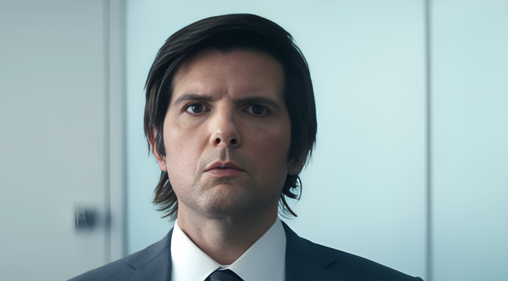 A group of suited office workers stands in a cold, minimalistic corporate setting. The atmosphere is sterile and mysterious, reflecting the psychological thriller tone of the series.