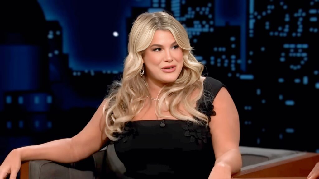 Heather McMahan smiling while discussing her neck job on Jimmy Kimmel Live with guest host Anthony Anderson.